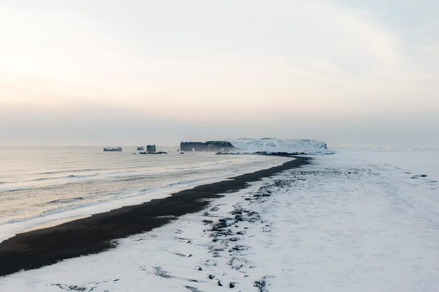From Reykjavík: 2-Day South Coast Adventure - Jökulsárlón glacier lagoon from shore, with icebergs and seals